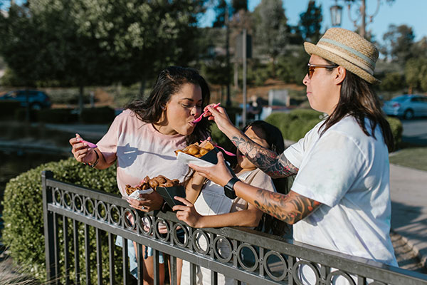 LGBTQ family eating on the street